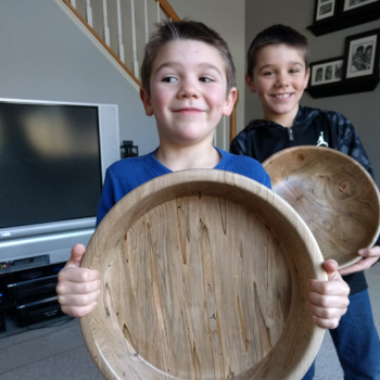 child holding wodden bowl